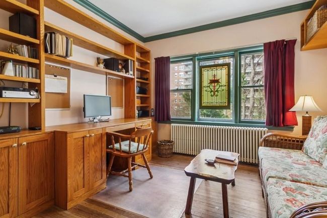 Study features pocket doors & built-in desk, storage & boolshelves | Image 10