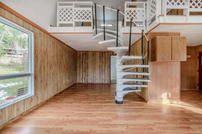 Stairway with wood walls and wood-type flooring | Image 15