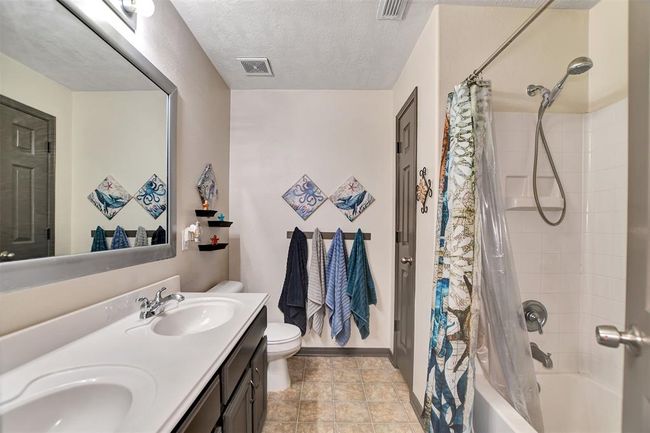 Modern bathroom with dual sinks, elegant fixtures, and a relaxing tub/shower combo. Perfect for convenience and comfort. | Image 41