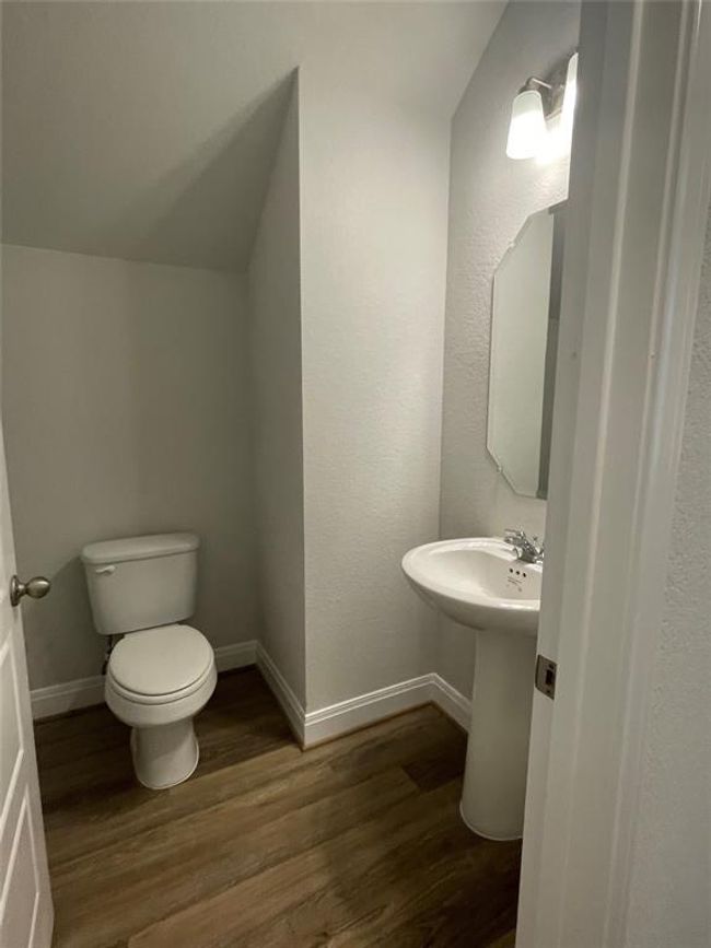 Half bath featuring wood finished floors and toilet | Image 15
