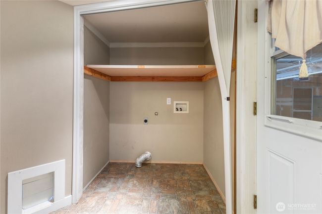 Downstairs utility room with cat door. | Image 25