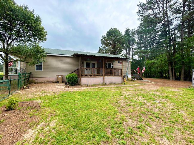 Rear view of house featuring a lawn, fence, and a wooden deck | Image 32