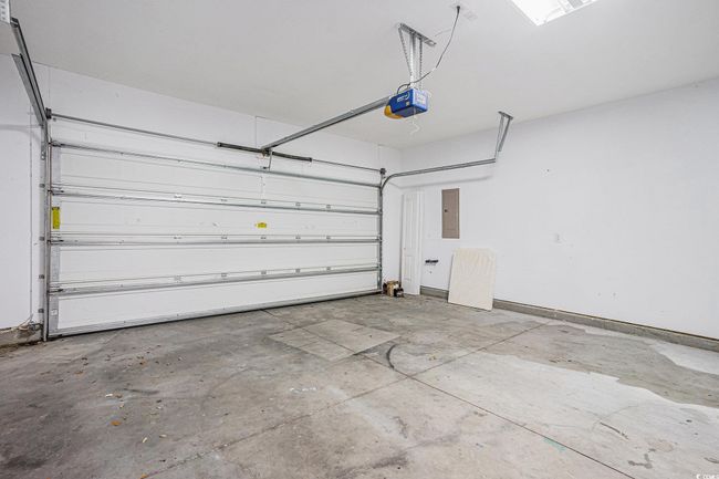 Garage with a garage door opener and electric panel | Image 18