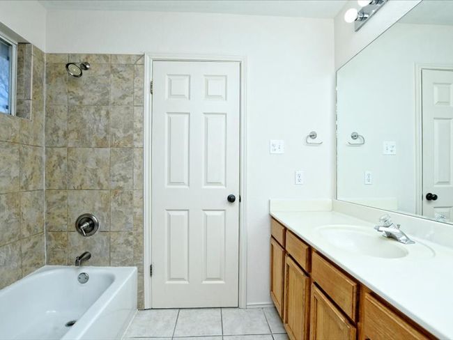 Full bathroom featuring tile patterned floors, vanity, and shower / bath combination | Image 16