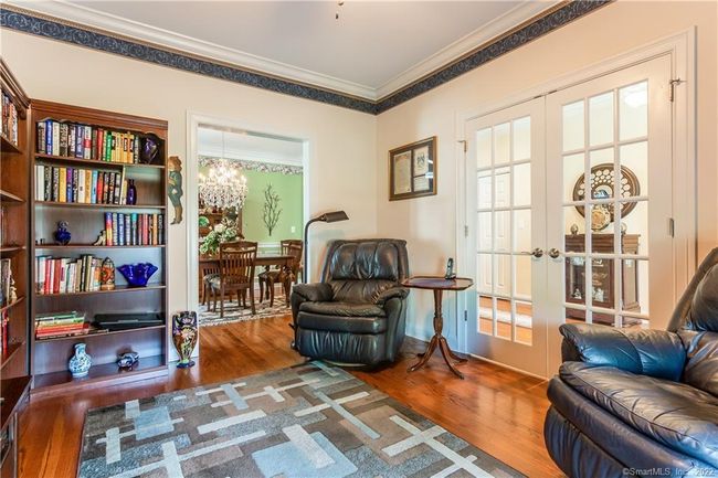 French doors lead from the foyer into the den. | Image 21