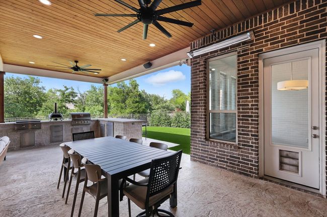 View of patio / terrace featuring exterior kitchen, ceiling fan, and outdoor dining area | Image 29