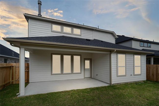 This backyard with its covered patio is enjoyable for everyone! From pets playing, kids jumping on the trampoline, or even having a garden, this amazing backyard provides space for endless activities for the whole family! | Image 20