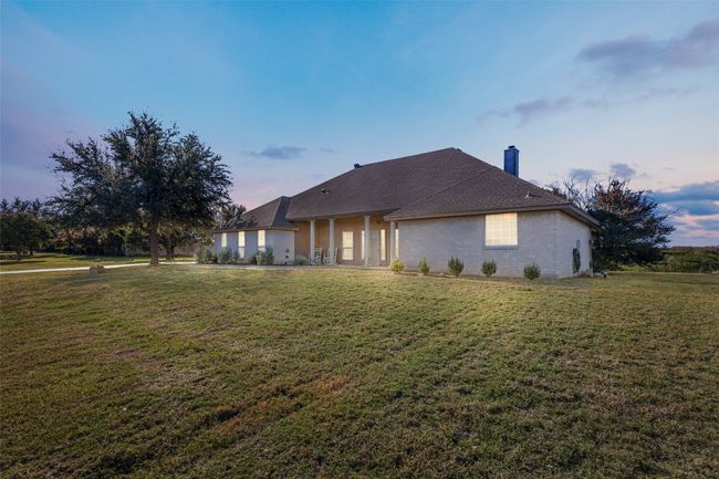 Back of house at dusk featuring a yard and a chimney | Image 23