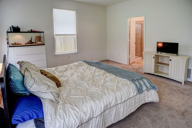 Bedroom with light colored carpet and baseboards | Image 23