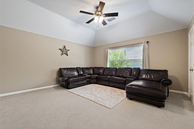 Tucked at the top of the stairs, the game room offers a versatile space that can shift with your needs—movie nights, study sessions, or a quiet place to unwind away from it all | Image 17