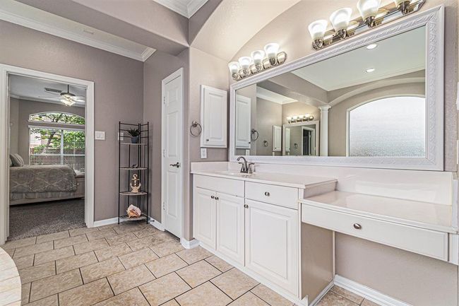 This bathroom boasts dual vanities, one with knee space and a drawer for storing those special items, or maybe a makeup station! | Image 23