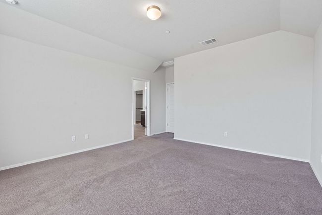 Spare room featuring vaulted ceiling and carpet | Image 20