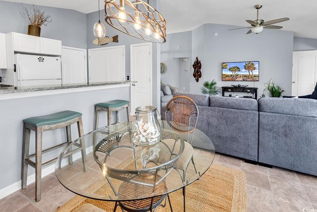 Dining room featuring ceiling fan and lofted ceiling | Image 24
