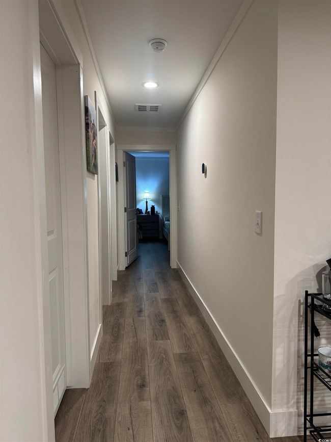 Corridor featuring dark wood-style floors and crown molding | Image 13
