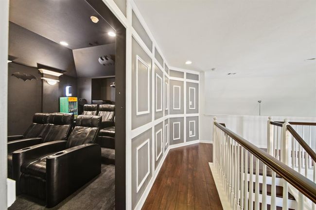 Tucked just off the game room behind a hidden door, this dedicated media room offers the perfect space to unwind with your favorite films in a true theater-style setting. | Image 35