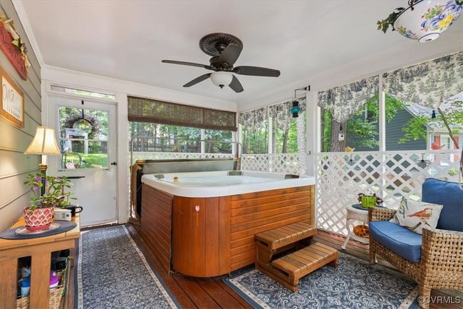 Sunroom with a jacuzzi and a ceiling fan | Image 37