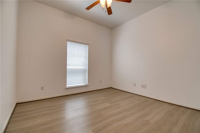 Spare room with a ceiling fan, baseboards, and light wood-style floors | Image 20
