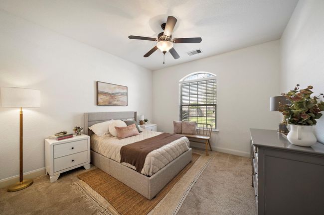 Relax in this inviting bedroom featuring plush carpeting and soft tones. Large windows allow abundant natural light, creating a warm and serene atmosphere. Ideal for personalization, this space offers a restful retreat for relaxation. | Image 25