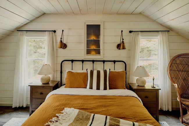 Bedroom with lofted ceiling, wood finished floors, wooden walls, multiple windows, and wood ceiling | Image 23