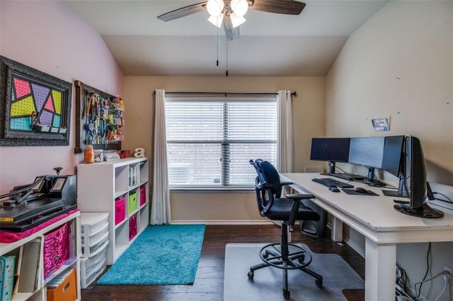 Office space with vaulted ceiling, wood finished floors, ceiling fan, and baseboards | Image 14