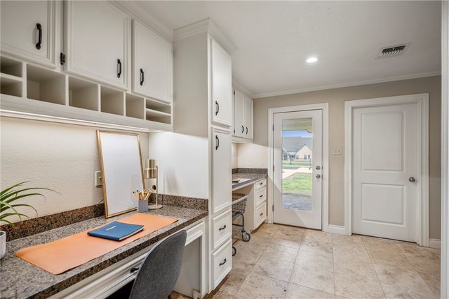 Office space with baseboards, visible vents, ornamental molding, built in desk, and recessed lighting | Image 18