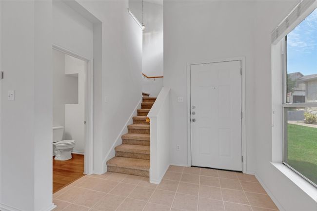 Entrance foyer featuring stairway and light tile patterned flooring | Image 7