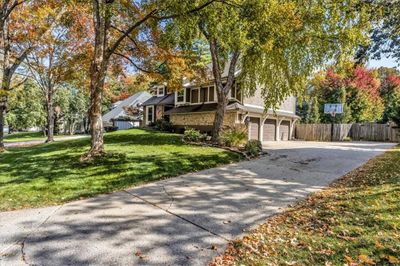 Front facade featuring a front lawn and a garage | Image 2