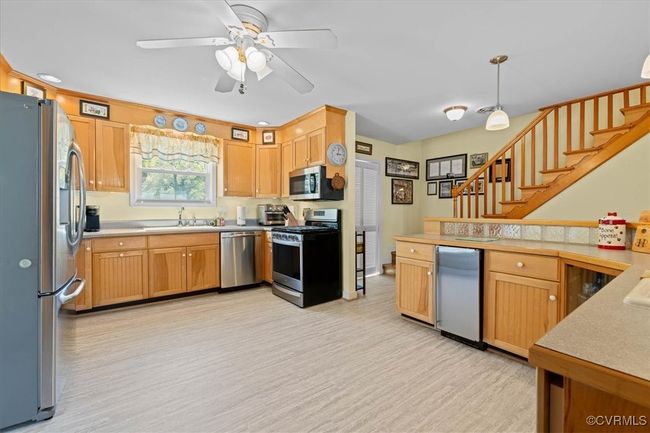 Another view of the open, airy kitchen, great for entertaining with raised bar with bar sink and space for all to enjoy. | Image 7