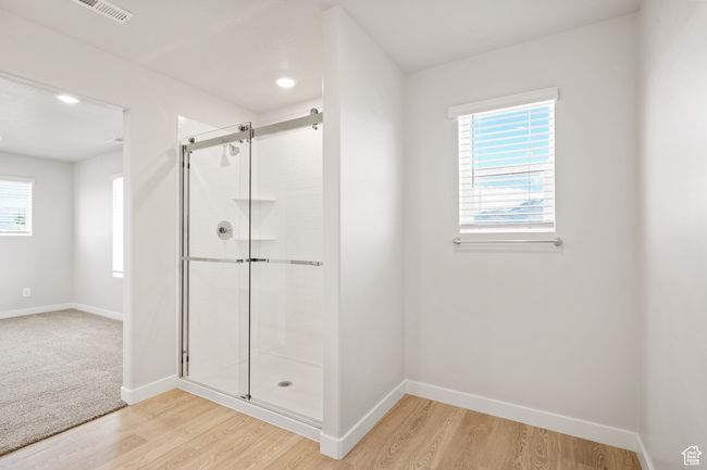 Bathroom with a shower stall, baseboards, wood finished floors, and recessed lighting | Image 35