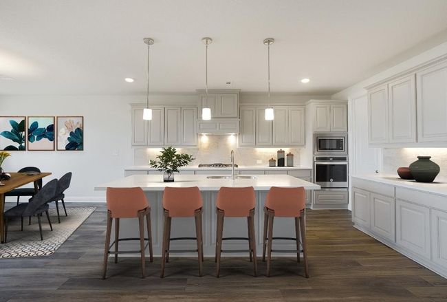 Kitchen with stainless steel appliances, a sink, light countertops, decorative backsplash, and recessed lighting | Image 4