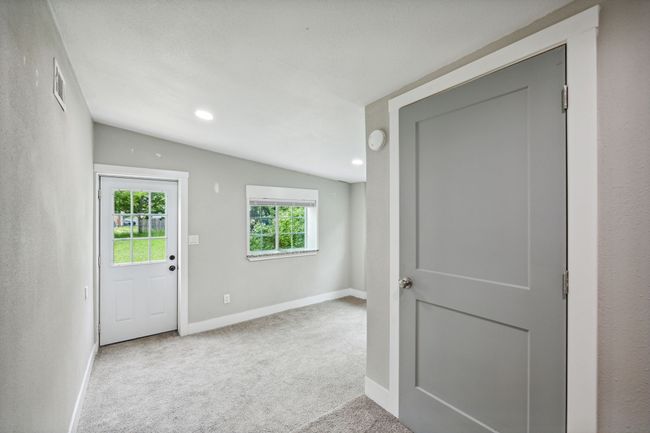 Entrance foyer with light carpet, recessed lighting, and lofted ceiling | Image 18
