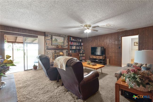Living room with wood-burning fireplace and built-in bookcase | Image 10