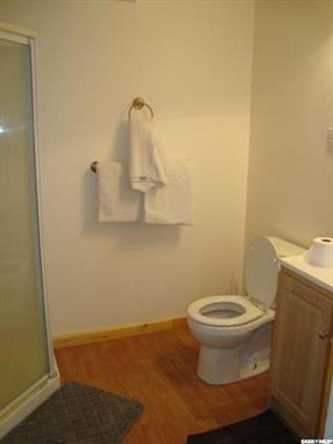 Bathroom with a shower with shower door, toilet, vanity, and hardwood / wood-style flooring | Image 47