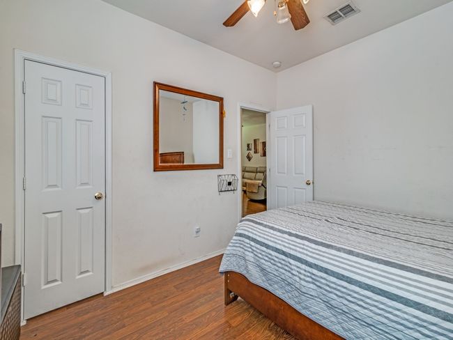 Bedroom featuring wood finished floors, visible vents, a ceiling fan, and baseboards | Image 14