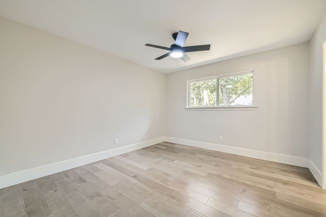 Unfurnished room with baseboards, ceiling fan, and light wood-style floors | Image 22