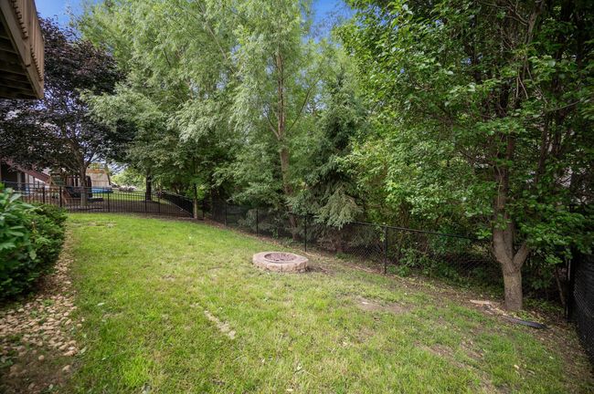 Yard is fully fenced, and has a fire ring ready for s'mores. | Image 32