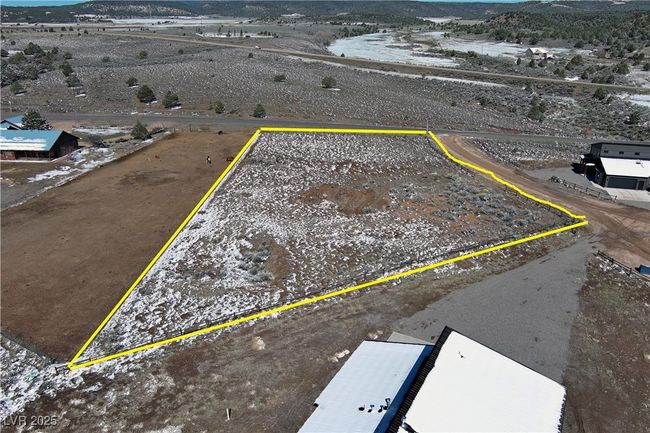 Aerial view of property and surrounding area with mountains and property parcel outlined | Image 9