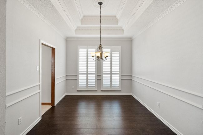 This formal dining area has room for a large table and a china cabinet. The tray ceiling has an executive feel. The neutral colors create an airy feel. | Image 17