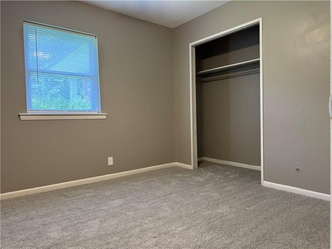 Unfurnished bedroom with carpet and a closet | Image 9