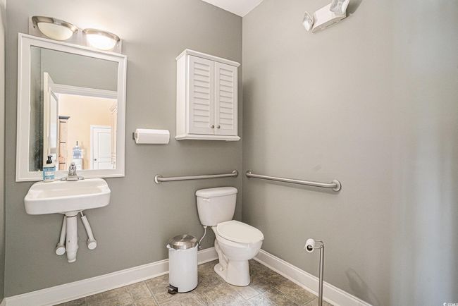 Bathroom with toilet and tile patterned floors | Image 16