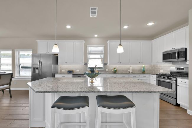Abundant granite counter top space and an over the sink window make preparing meals for family and guests relaxing and enjoyable. | Image 8