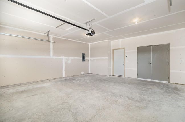 Insulated & Sheetrocked Garage, Insulated Garage Door with Decorative Window Grilles, Smart Door Opener with Keypad AND Electric Car Charger Outlet. | Image 17