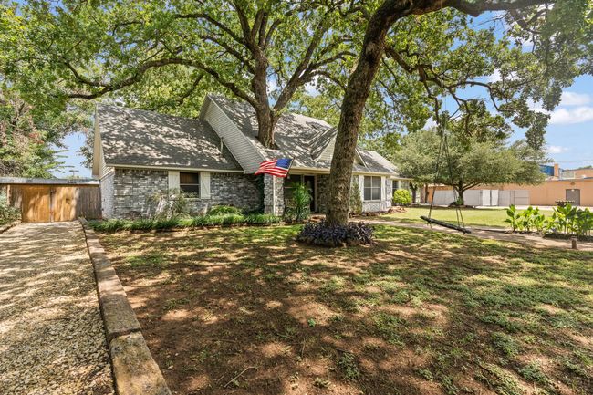 View of front of house with a shingled roof and brick siding | Image 4