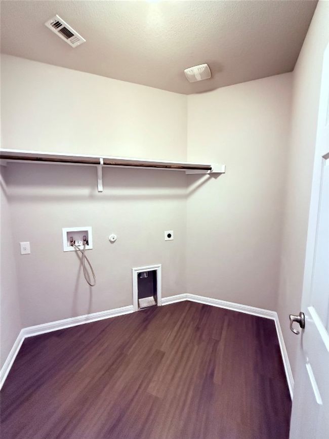 Laundry room with electric dryer hookup, dark wood-style flooring, gas dryer hookup, hookup for a washing machine, and baseboards | Image 10
