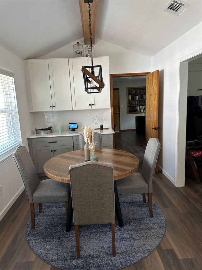 Dining room with dark wood-style flooring and baseboards | Image 9