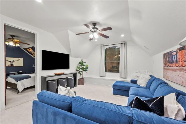 The oversized upstairs bonus room offers space to lounge, play, or watch movies, complete with a cozy sectional and natural light. | Image 32