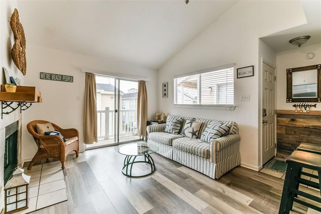 This second-floor unit offers a balcony off the living room and primary bedroom. | Image 6