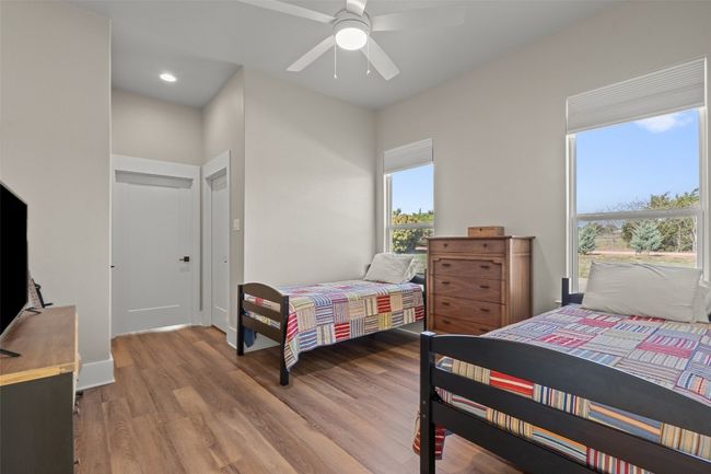 Bedroom with wood finished floors, ceiling fan, and recessed lighting | Image 23