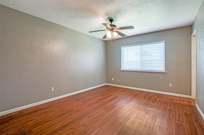 Unfurnished room featuring wood finished floors and a ceiling fan | Image 13