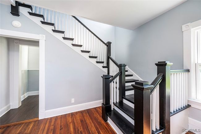 Living area featuring a ceiling fan, wood finished floors, stairs, french doors, and baseboards | Image 10